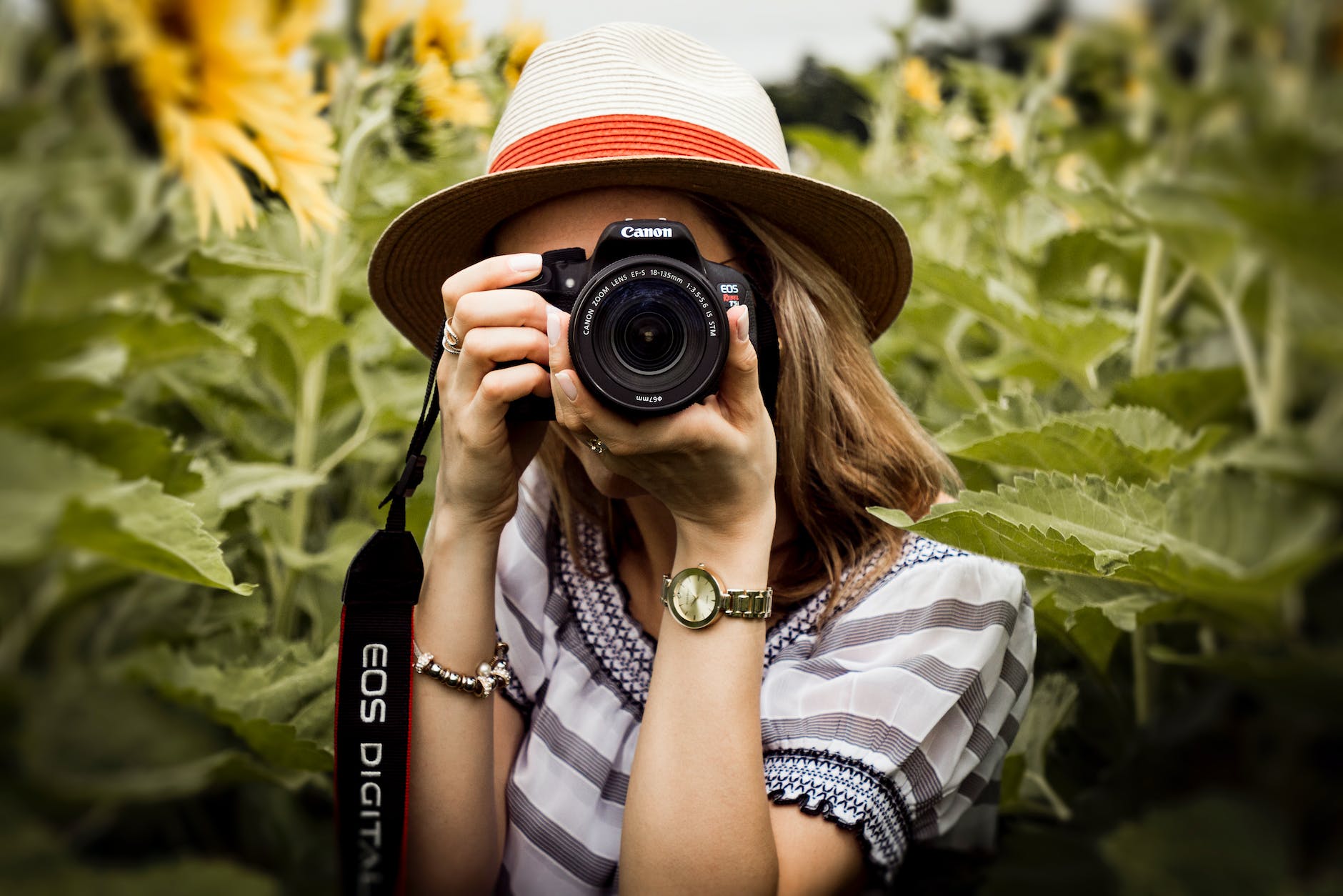 selective focus photography of woman holding dslr camera